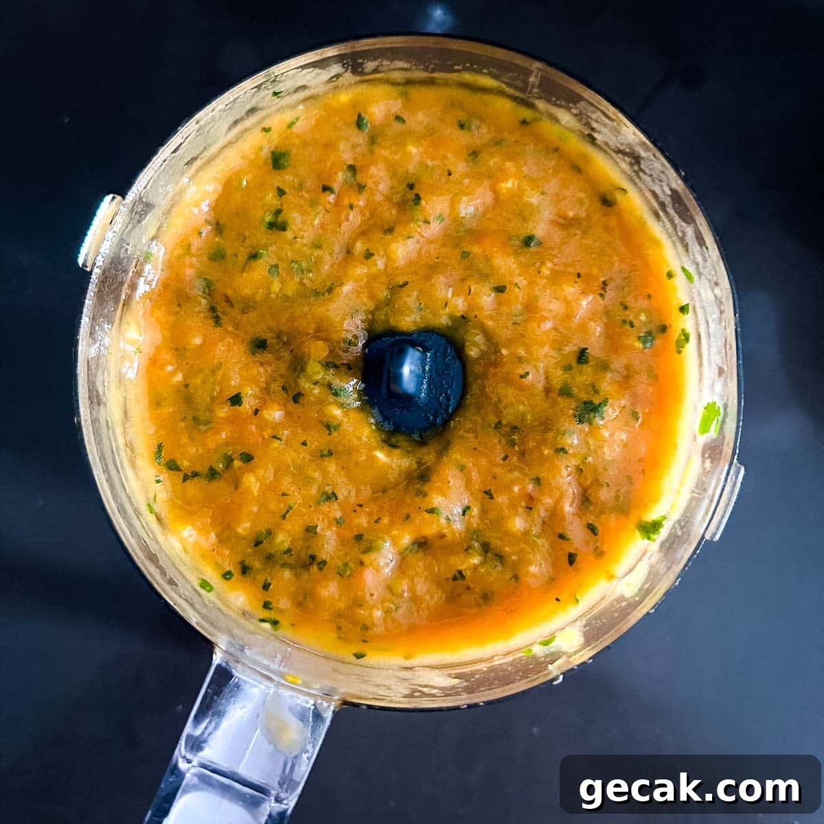 Blended mango habanero salsa in a mini food processor.