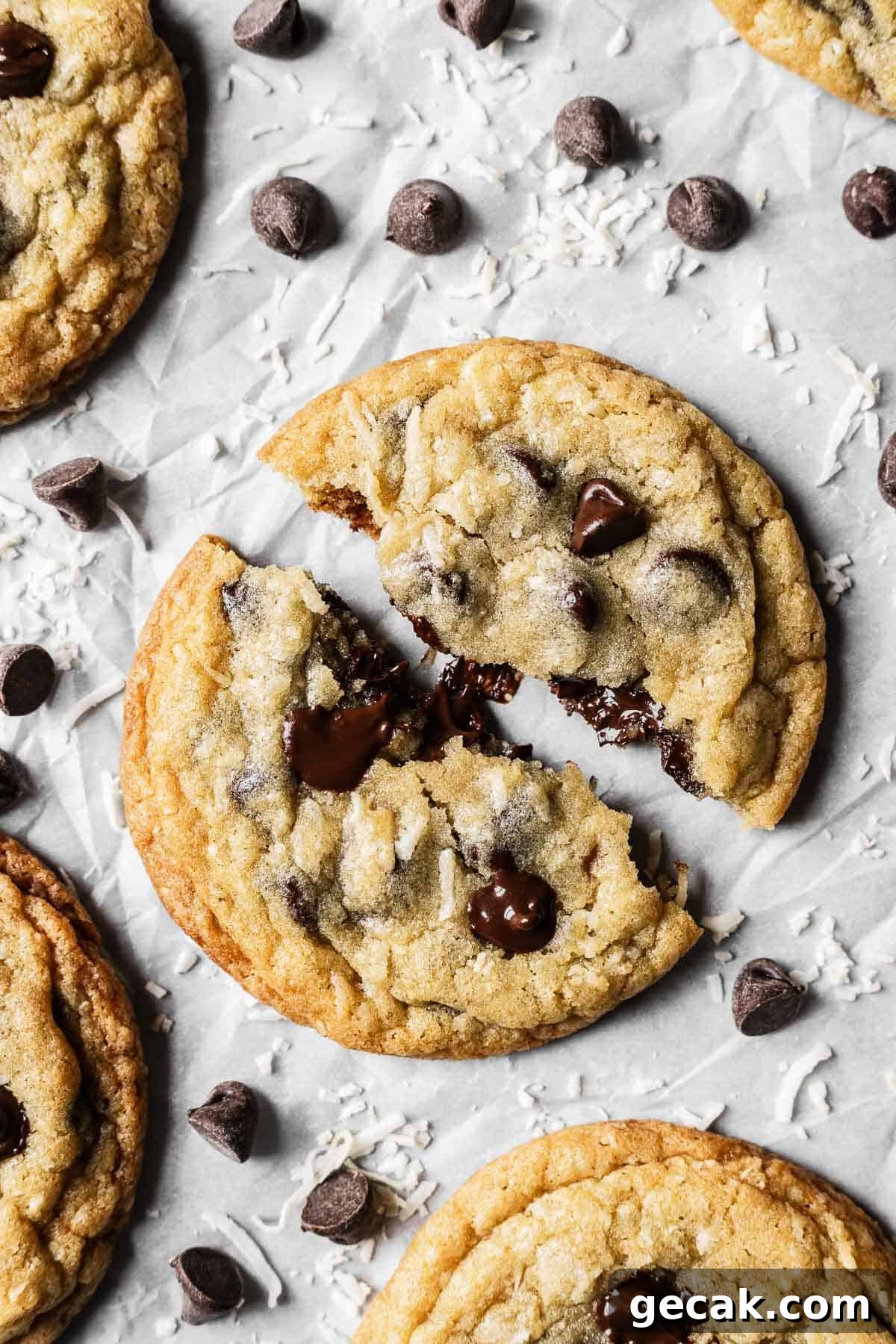 A large cookie split in half showing melted chocolate chips and a gooey center.