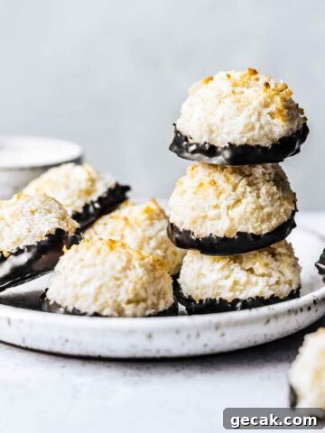 Chocolate dipped german macaroon cookies on a white ceramic plate.