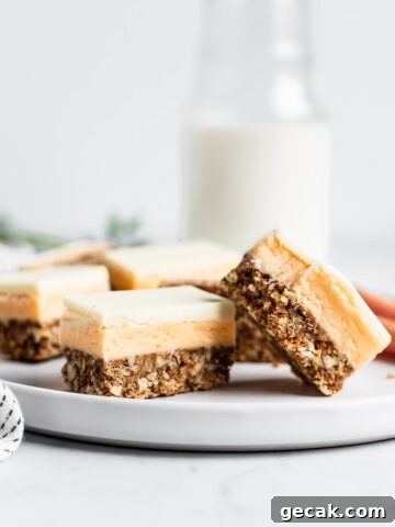 Sliced bars on a white plate with carrots and a jug of milk in the background