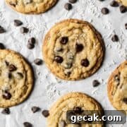 Baked coconut chocolate chip cookies on parchment paper.