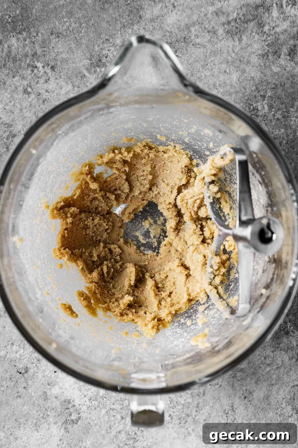 Butter and sugars creamed together in a mixing bowl.