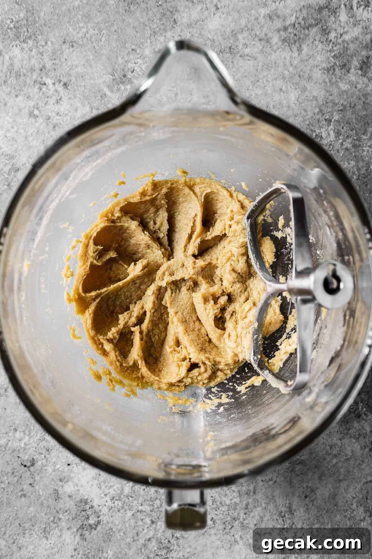 Wet ingredients beaten with butter and sugar in a mixing bowl.