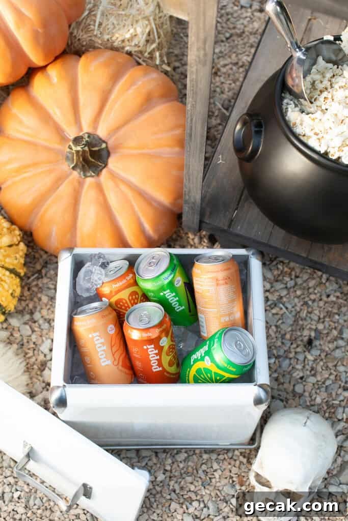 An ice bucket filled with orange and green sodas. 