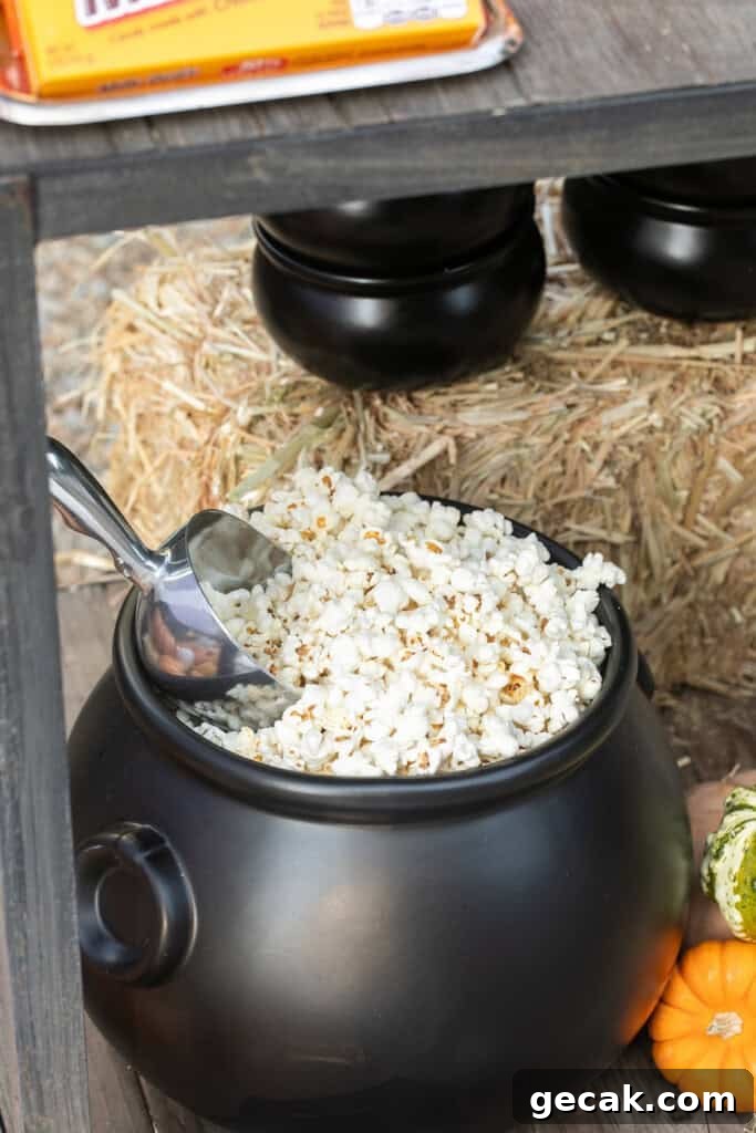Fresh popcorn in a black cauldron. 