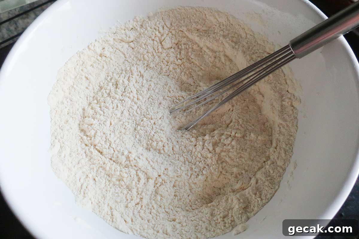 10 Essential Ingredients Every Gluten-Free Pantry Needs 3 flour mixture in a bowl with a whisk